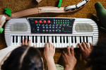 learn to play a song on a toy musical instrument